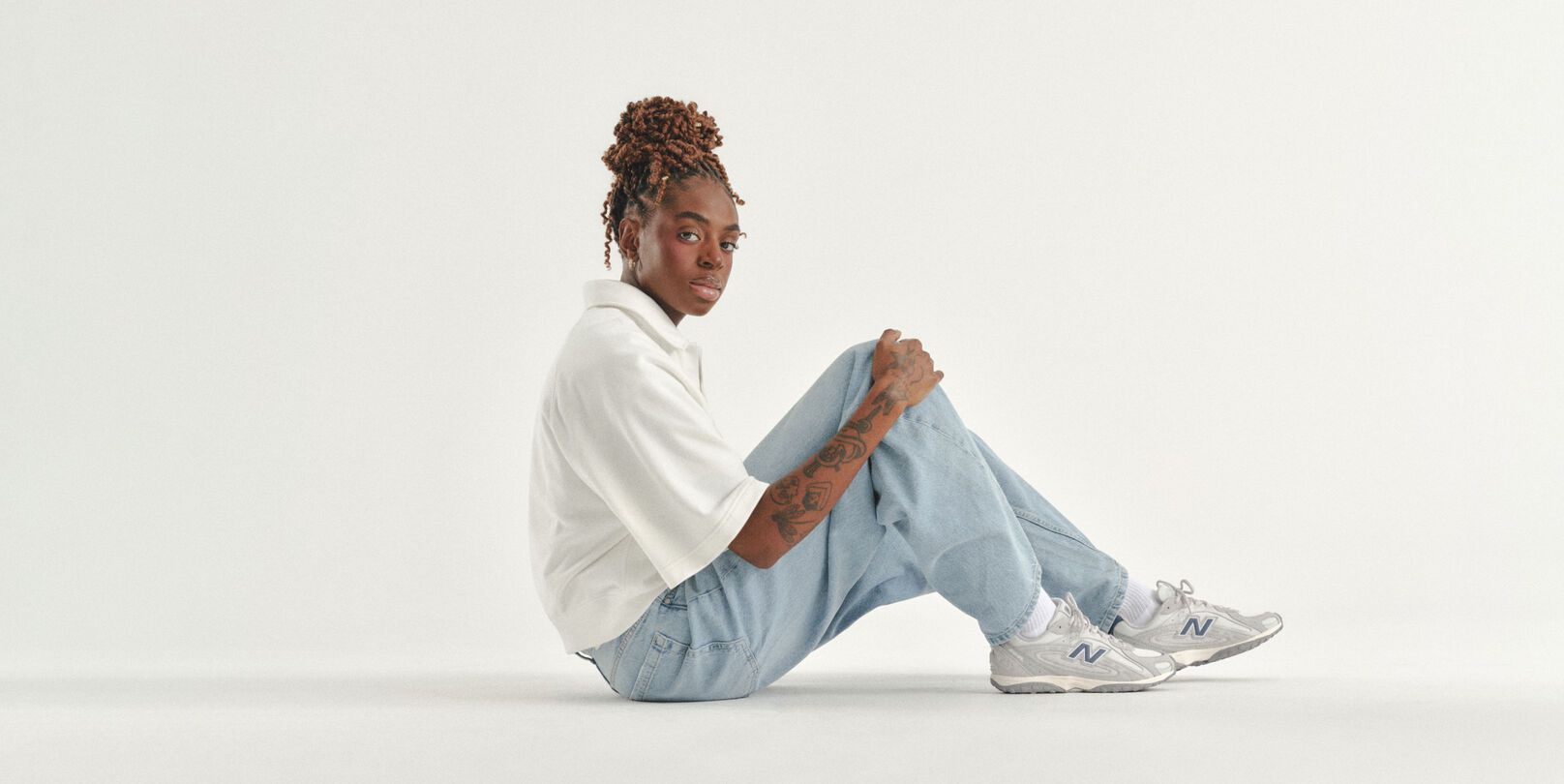 Can Burns sitting on a white studio backdrop. 