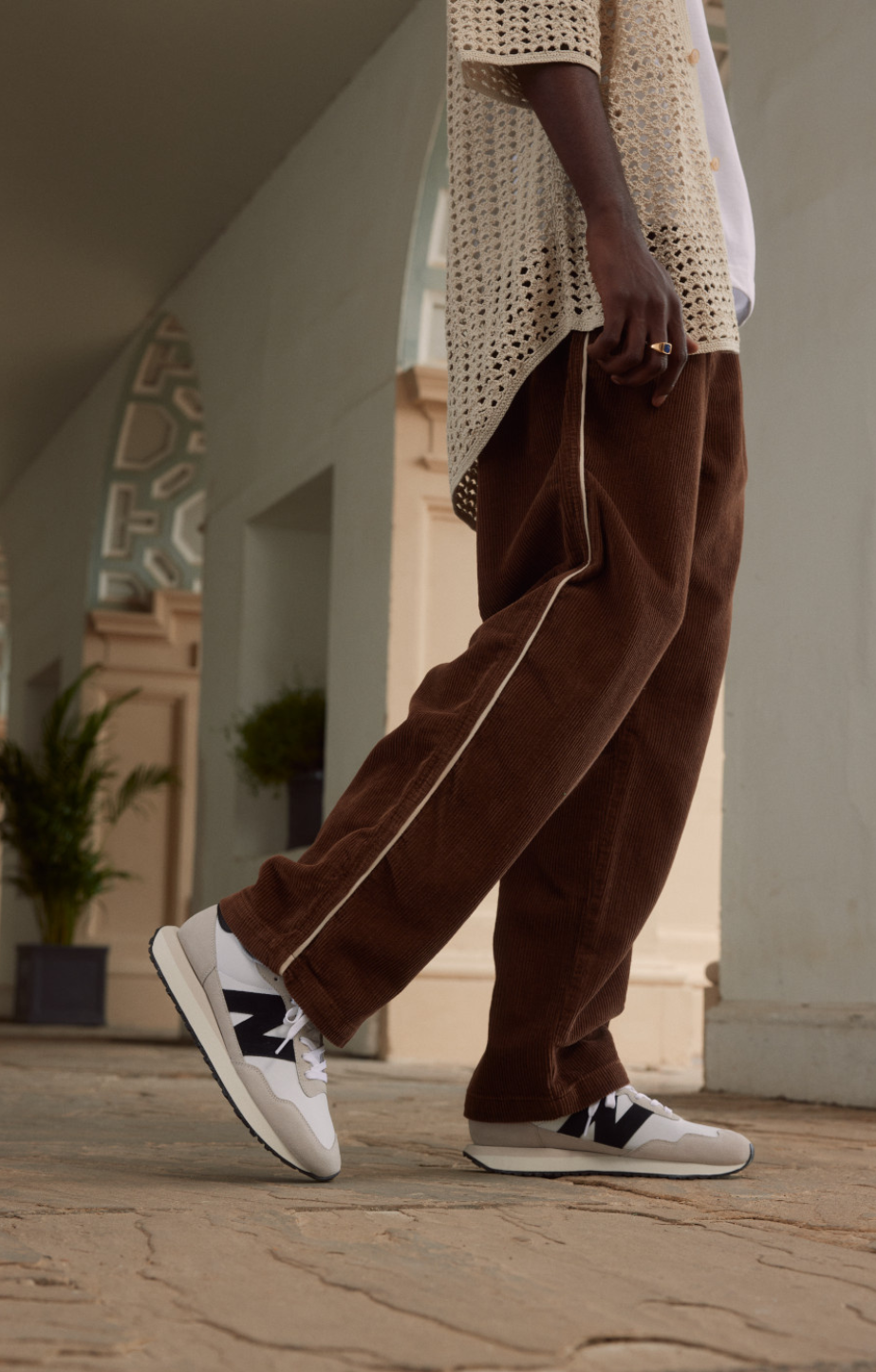 A man standing in a house wearing New Balance 237's