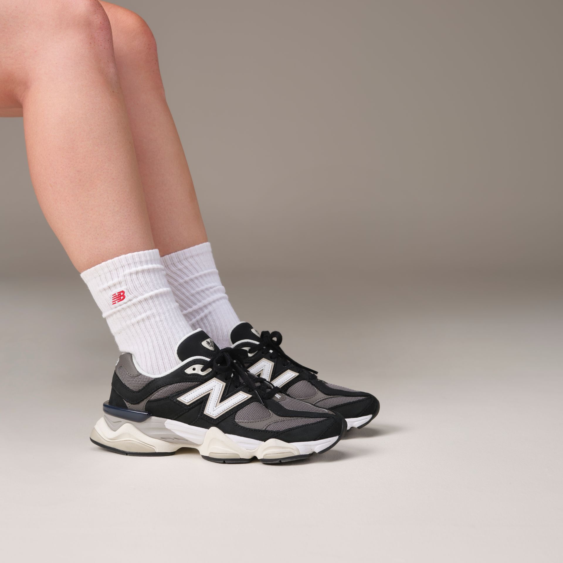 woman in studio background wearing 9060 sneakers