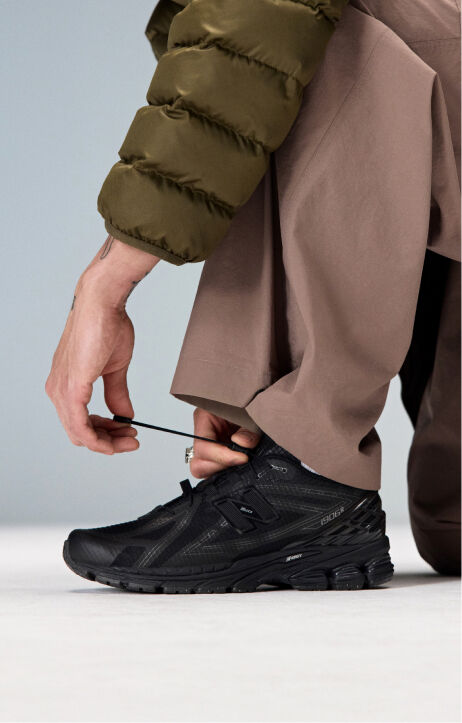 Close up of someone wearing new balance 1906 sneakers