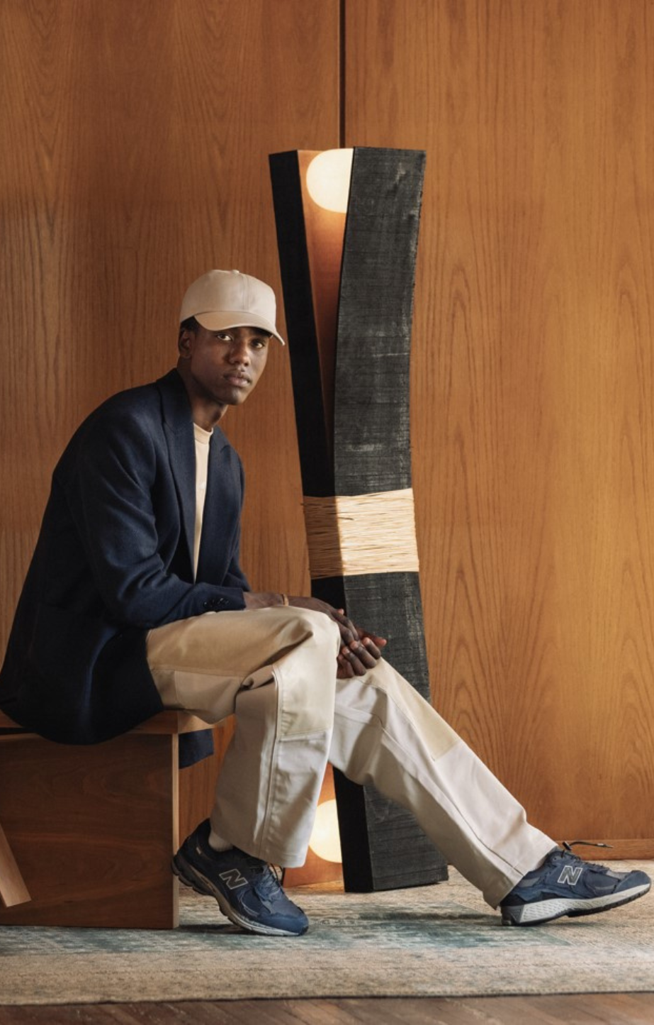 man sitting wearing new balance 2002r shoes