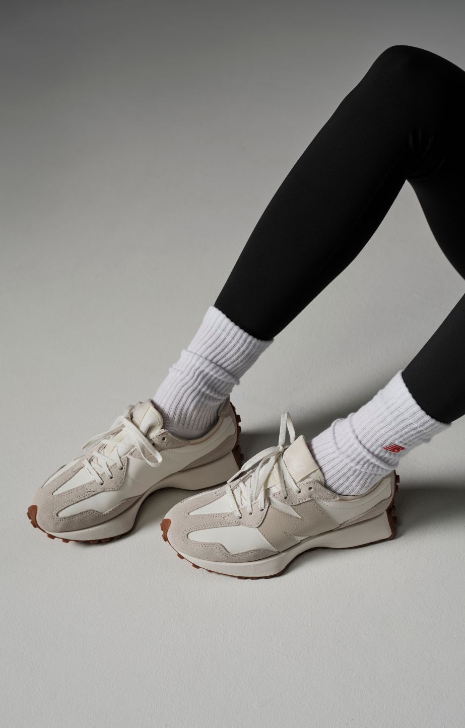 closeup shot of a woman's legs wearing 327 sneakers