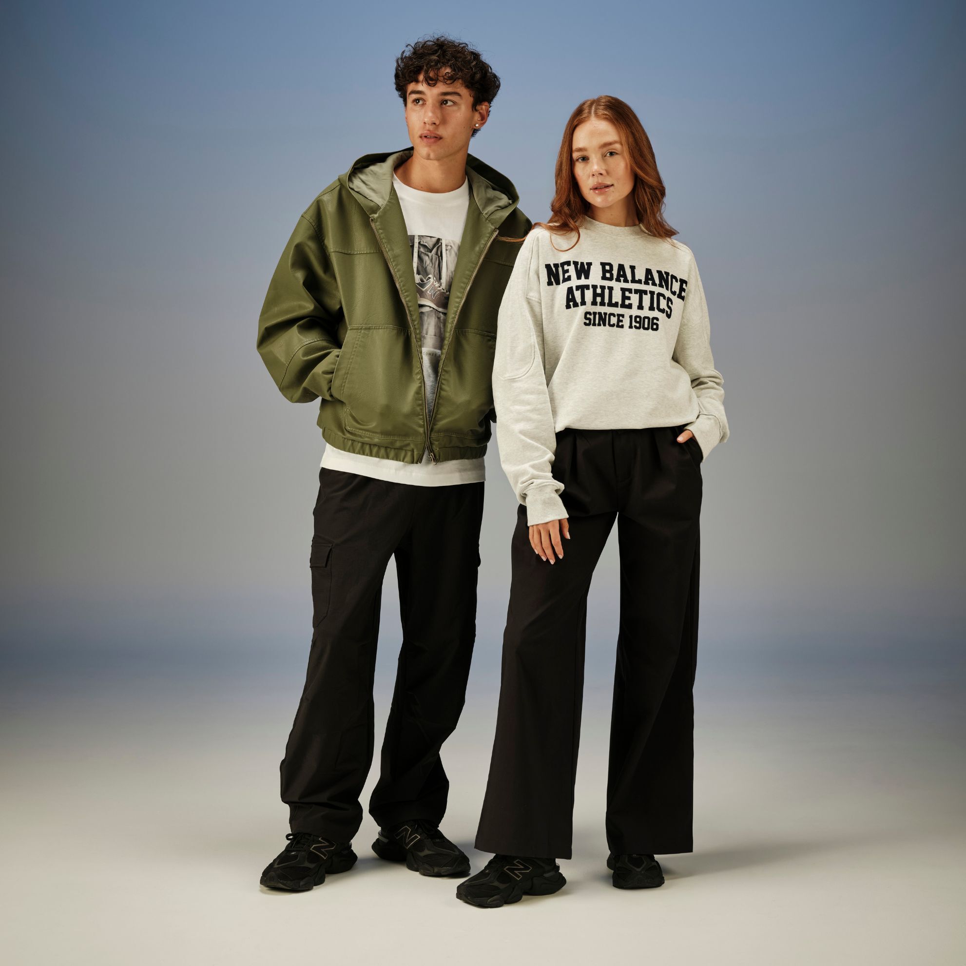 A man and woman in studio wearing the New Balance 9060 in Black with Black Cement