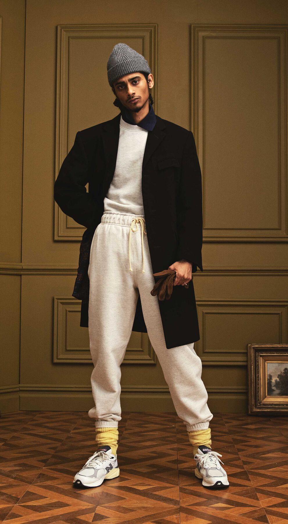Man standing in a beautiful indoor environment wearing apparel and footwear from the SS ‘22 MADE in USA Collection.