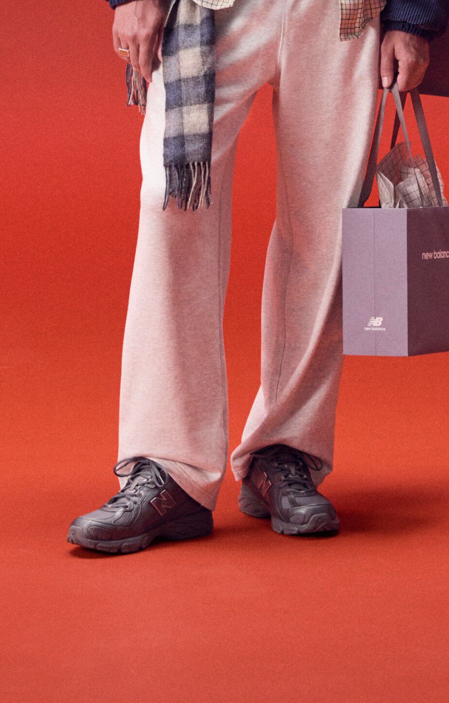 Close up a persons legs wearing new balance 740s