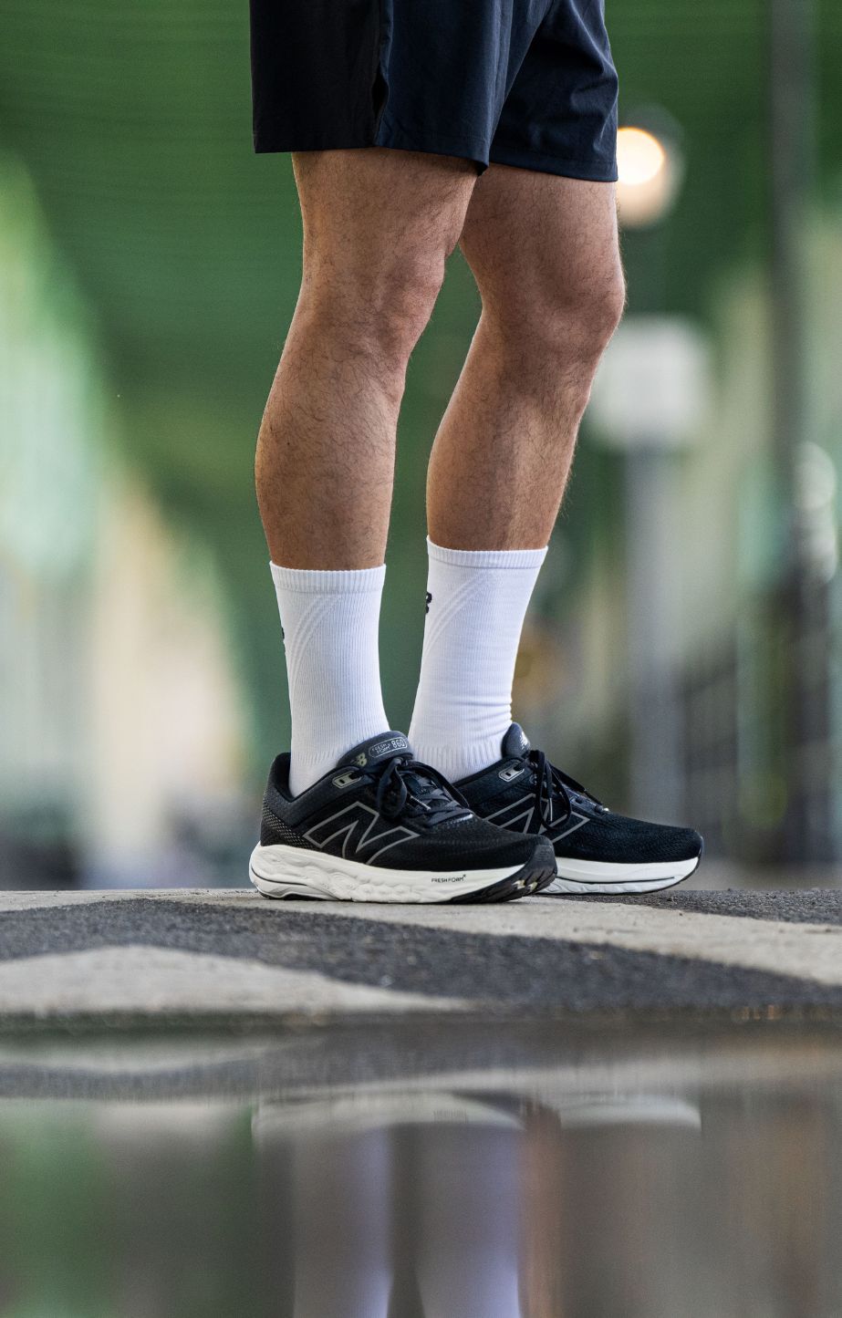 Mans legs wearing new balance fresh foam 860 running shoes