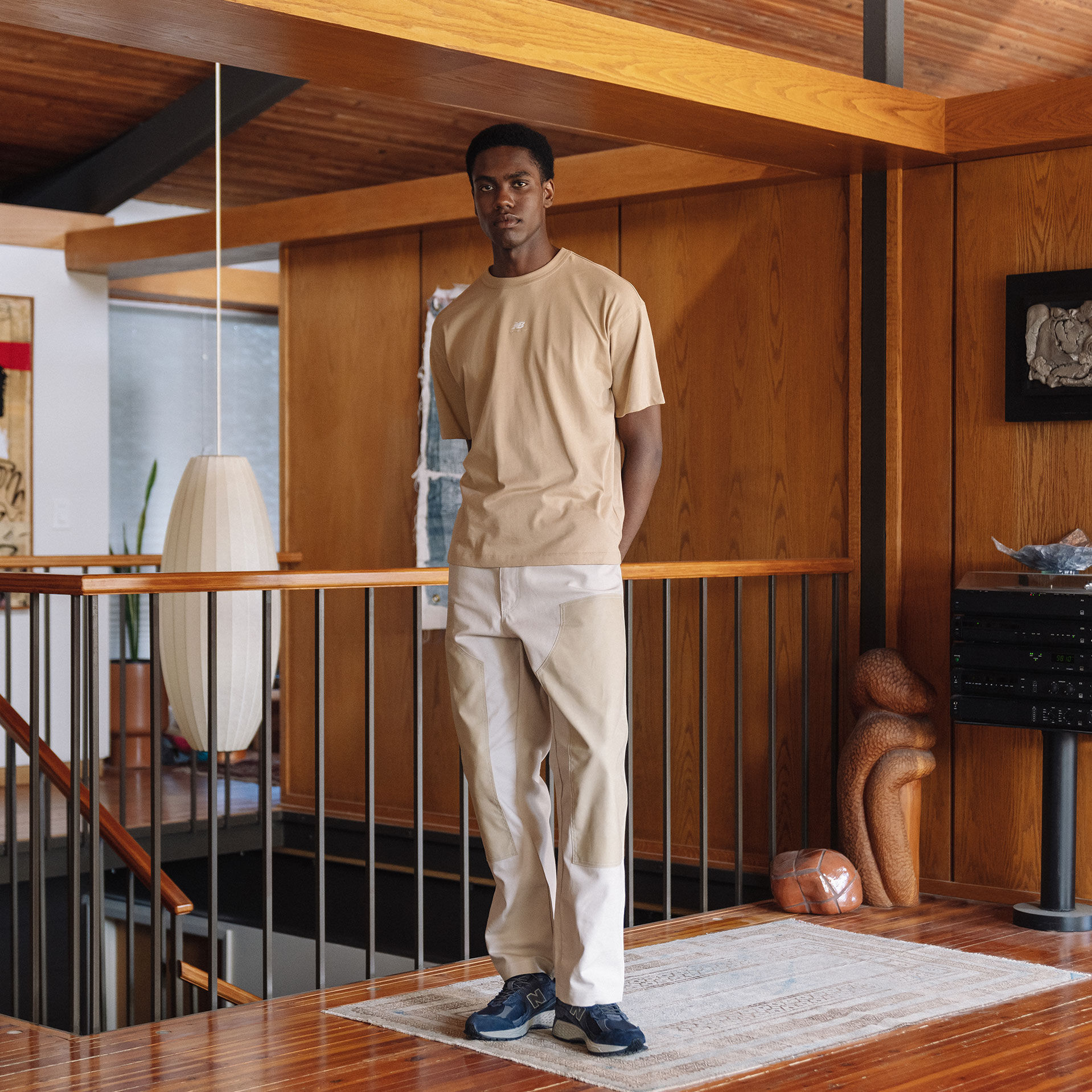 Men wearing neutral tshirt and chinos wearing New Balance 2002R.
