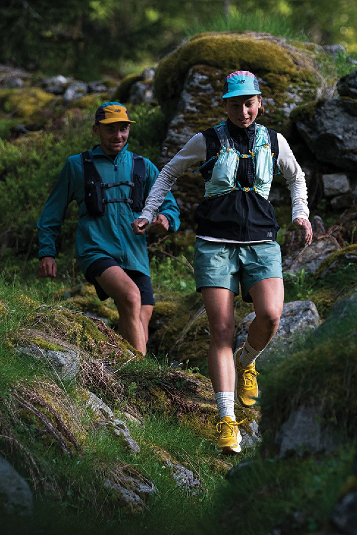 Two people running on a trail 