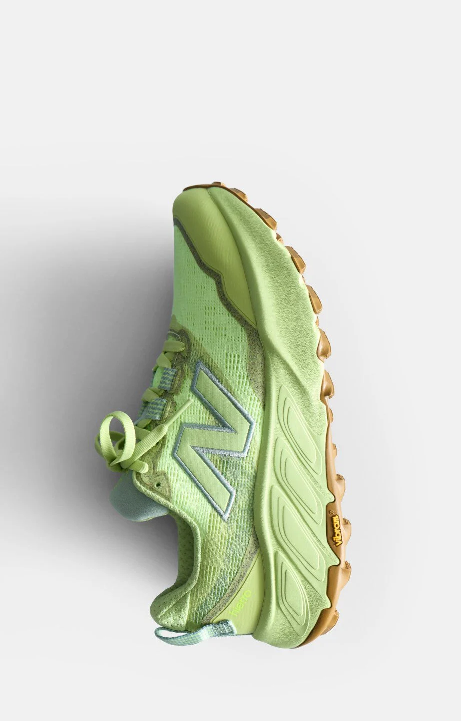 Light green sneaker with a thick sole and a New Balance logo, shown on a white background. 