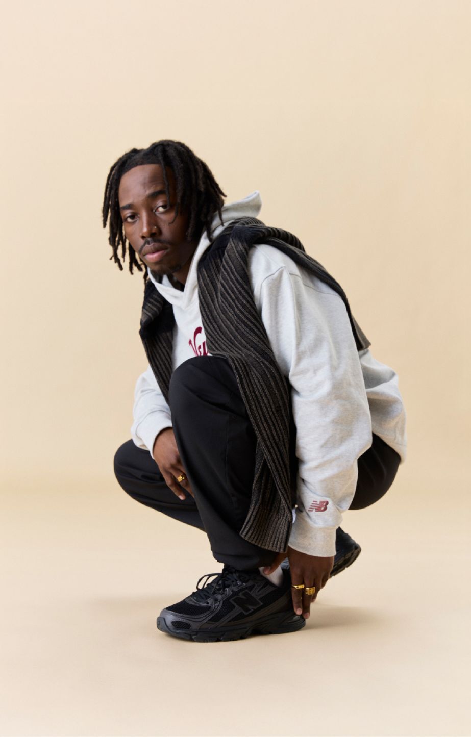 Man kneeling down, wearing new balance 740 sneakers