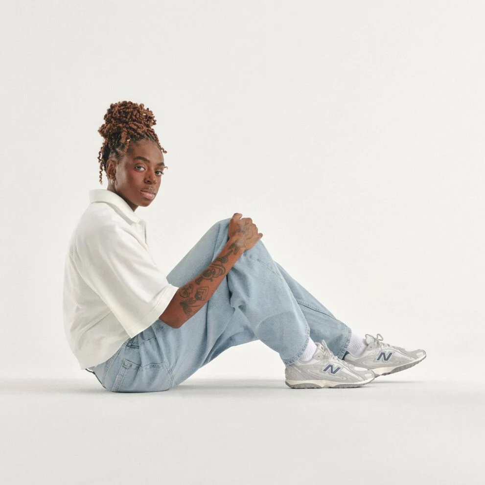 Can Burns sitting on a white studio backdrop. 