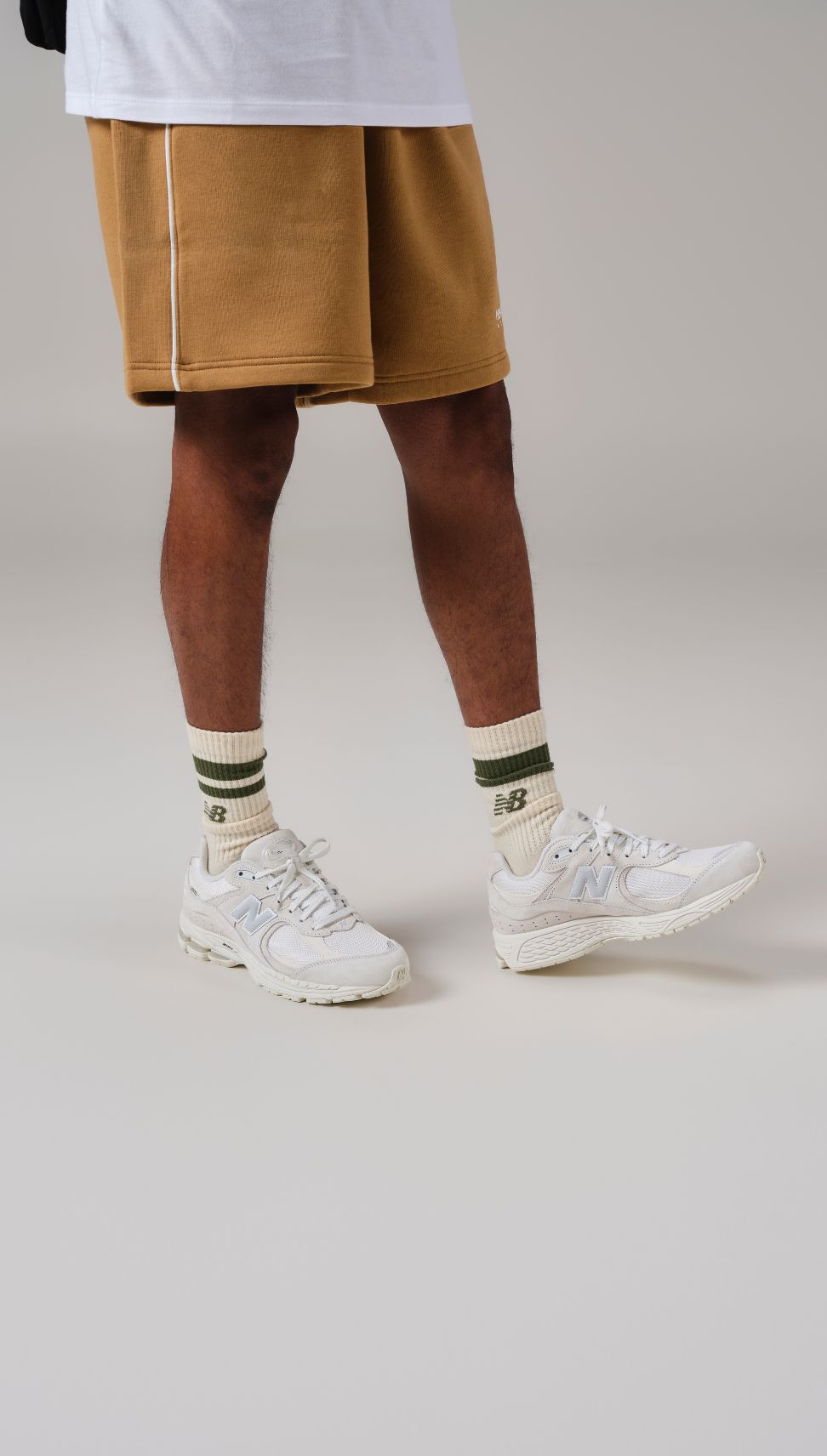 Close up of someone wearing new balance 2002s