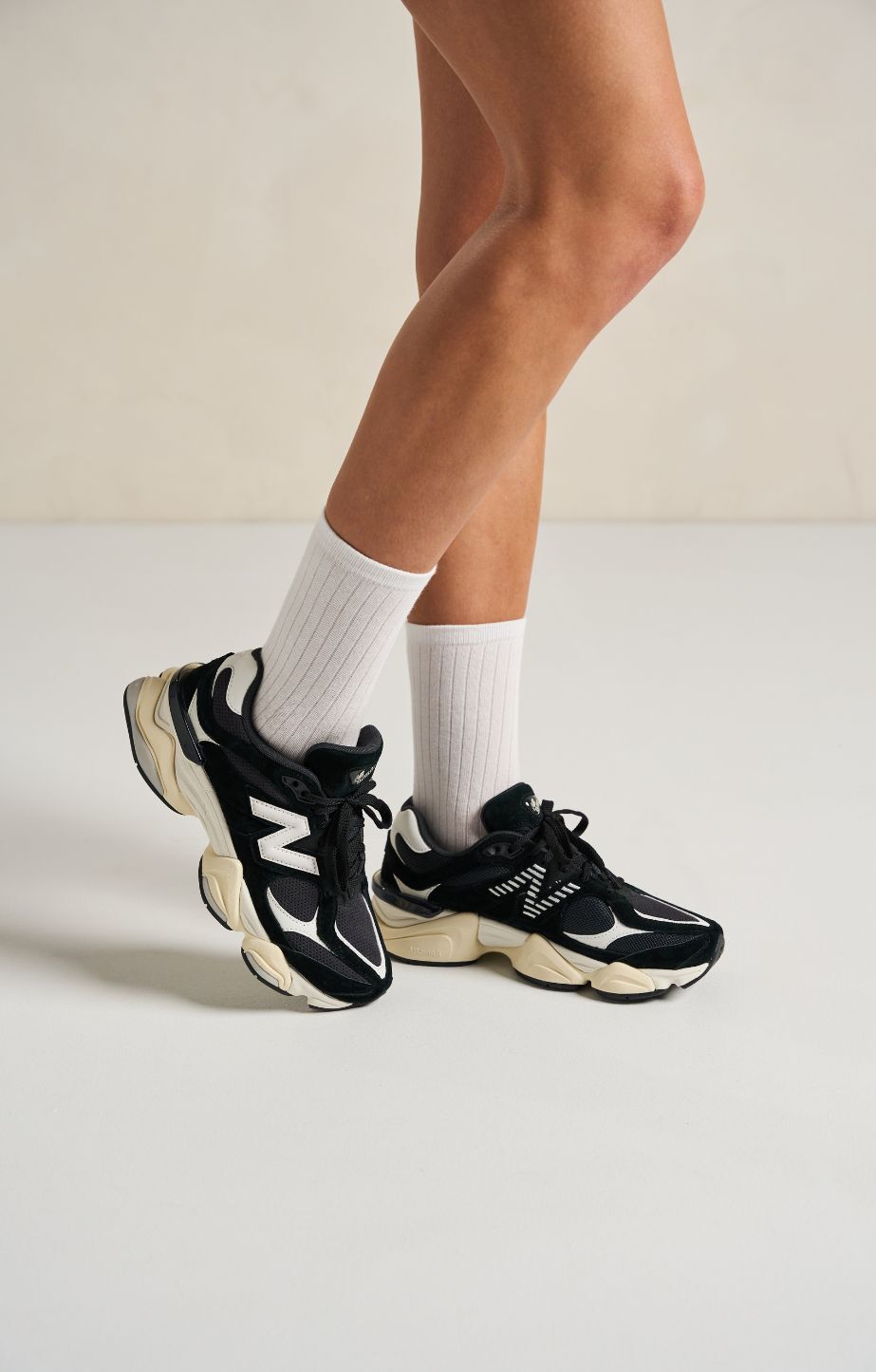 Close up of persons legs wearing new balance 9060 sneakers