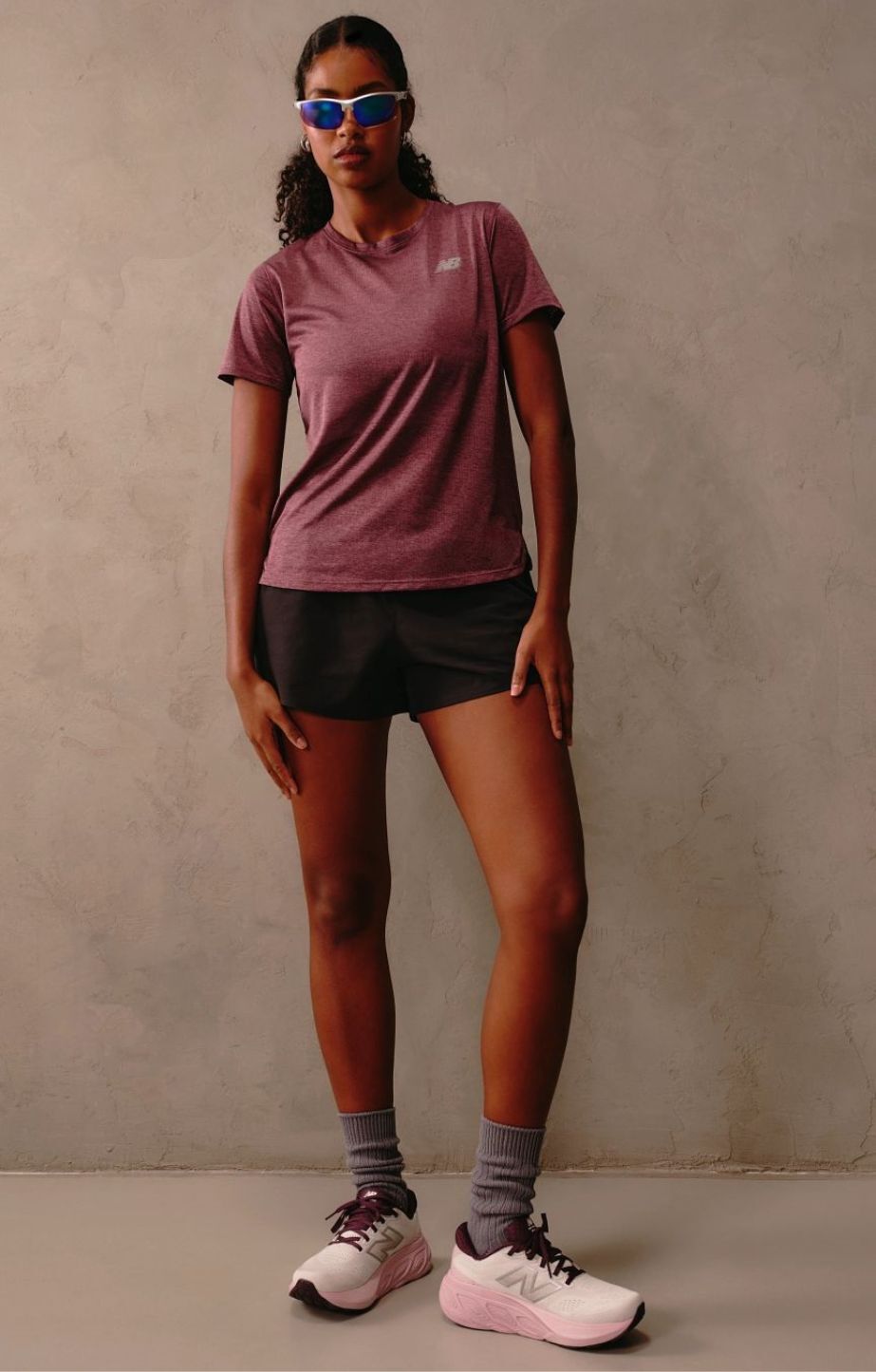 Woman standing, while wearing new balance apparel and new balance fresh foam 880 running shoes