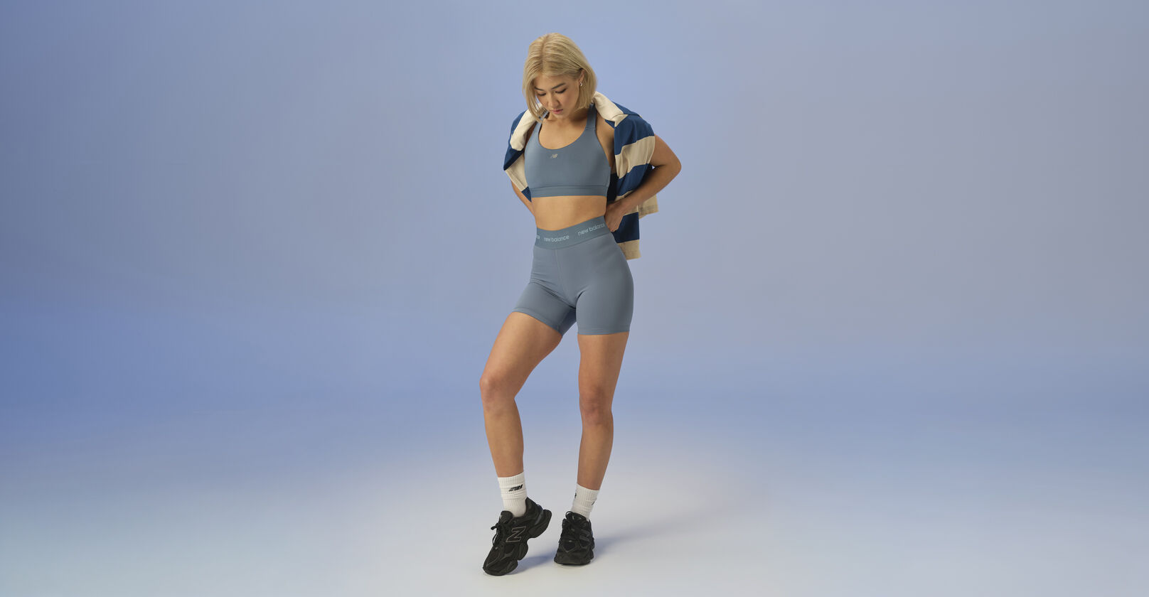 woman posing in studio wearing 9060 sneakers