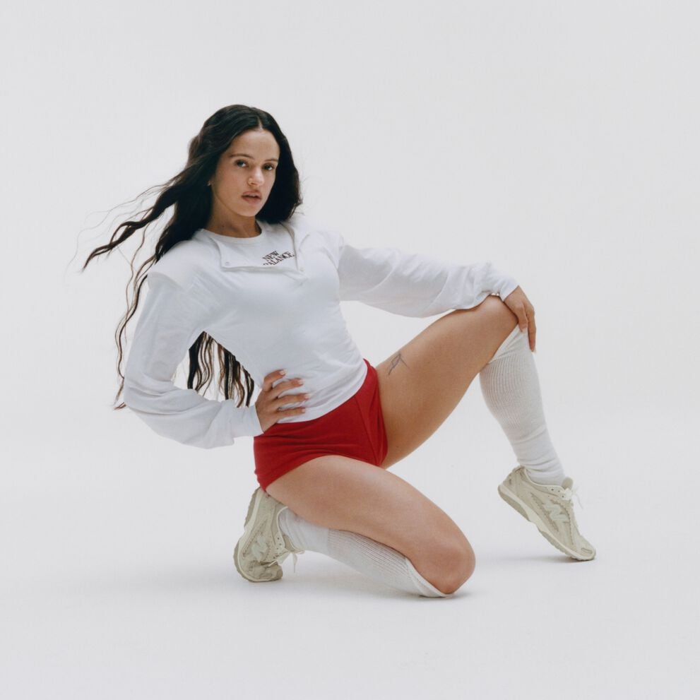Rosal&iacute;a kneeling on a white studio backdrop. 