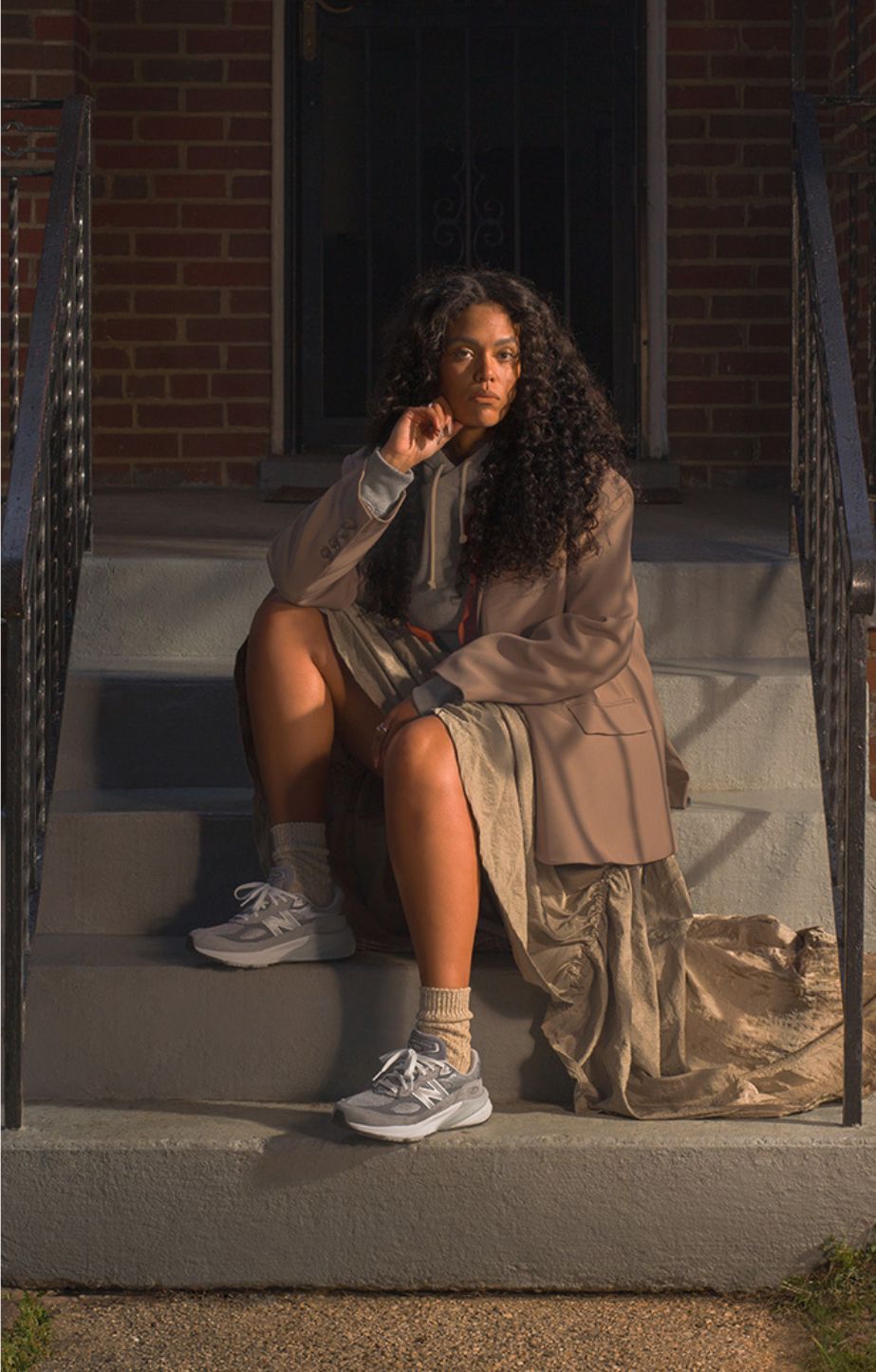 women sitting on step wearing 990v6