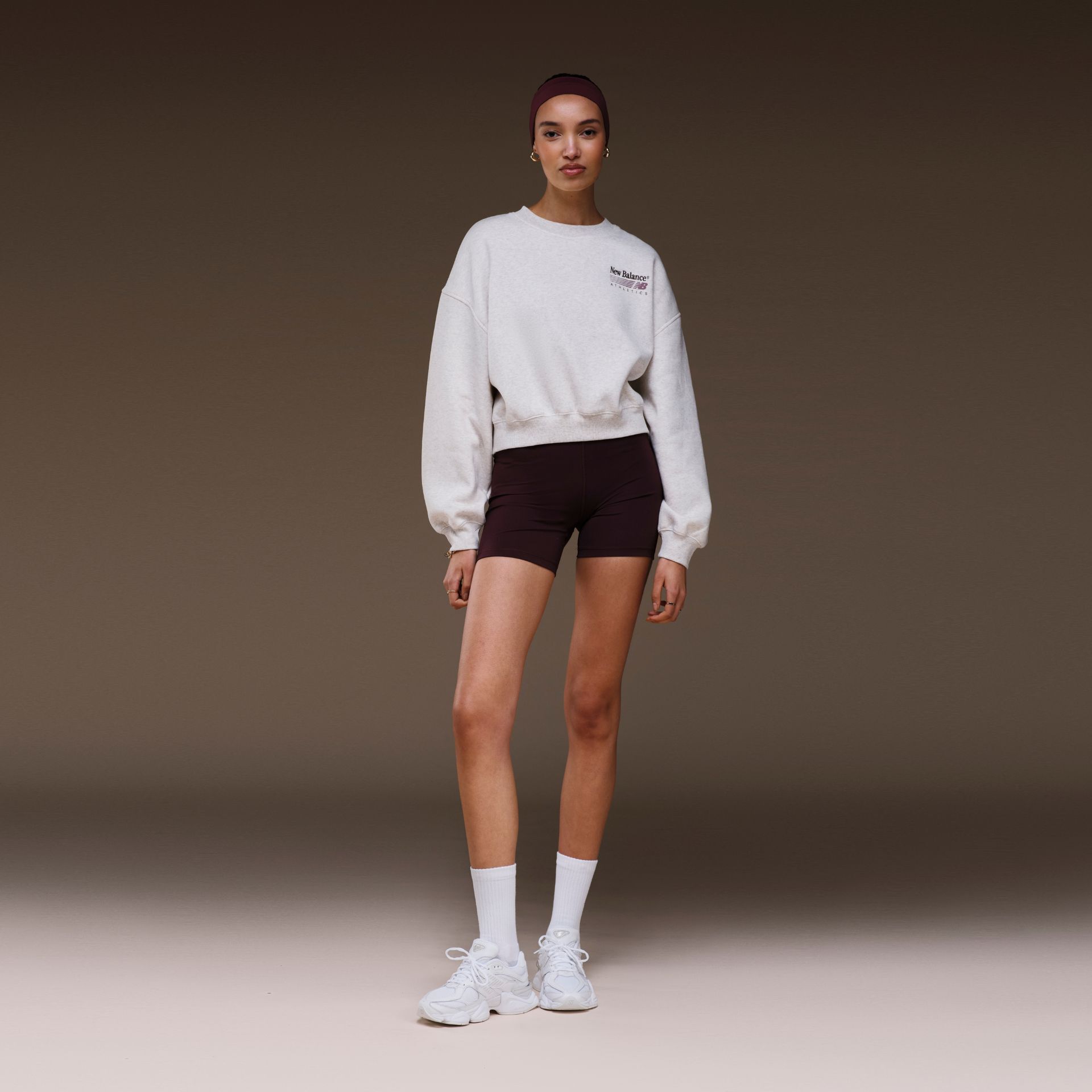 Woman in a studio background wearing 9060 sneakers