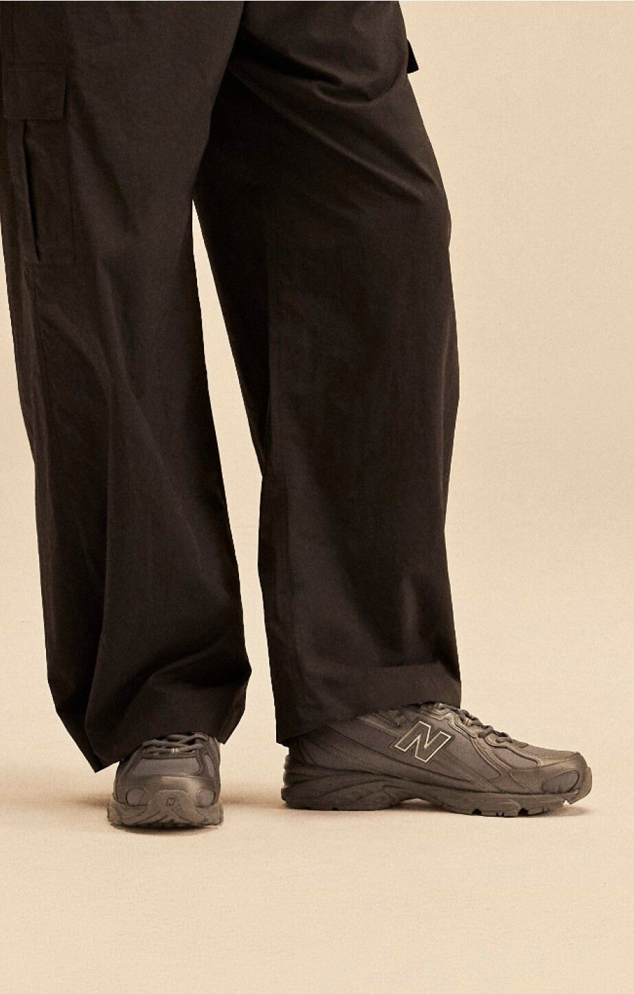 Close up a persons legs wearing new balance 740s