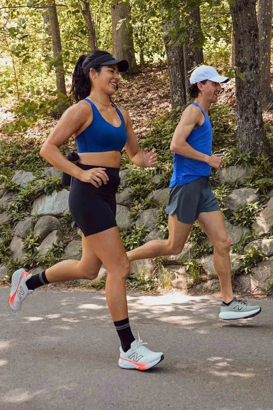 Man and woman running outdoors wearing 880 runners