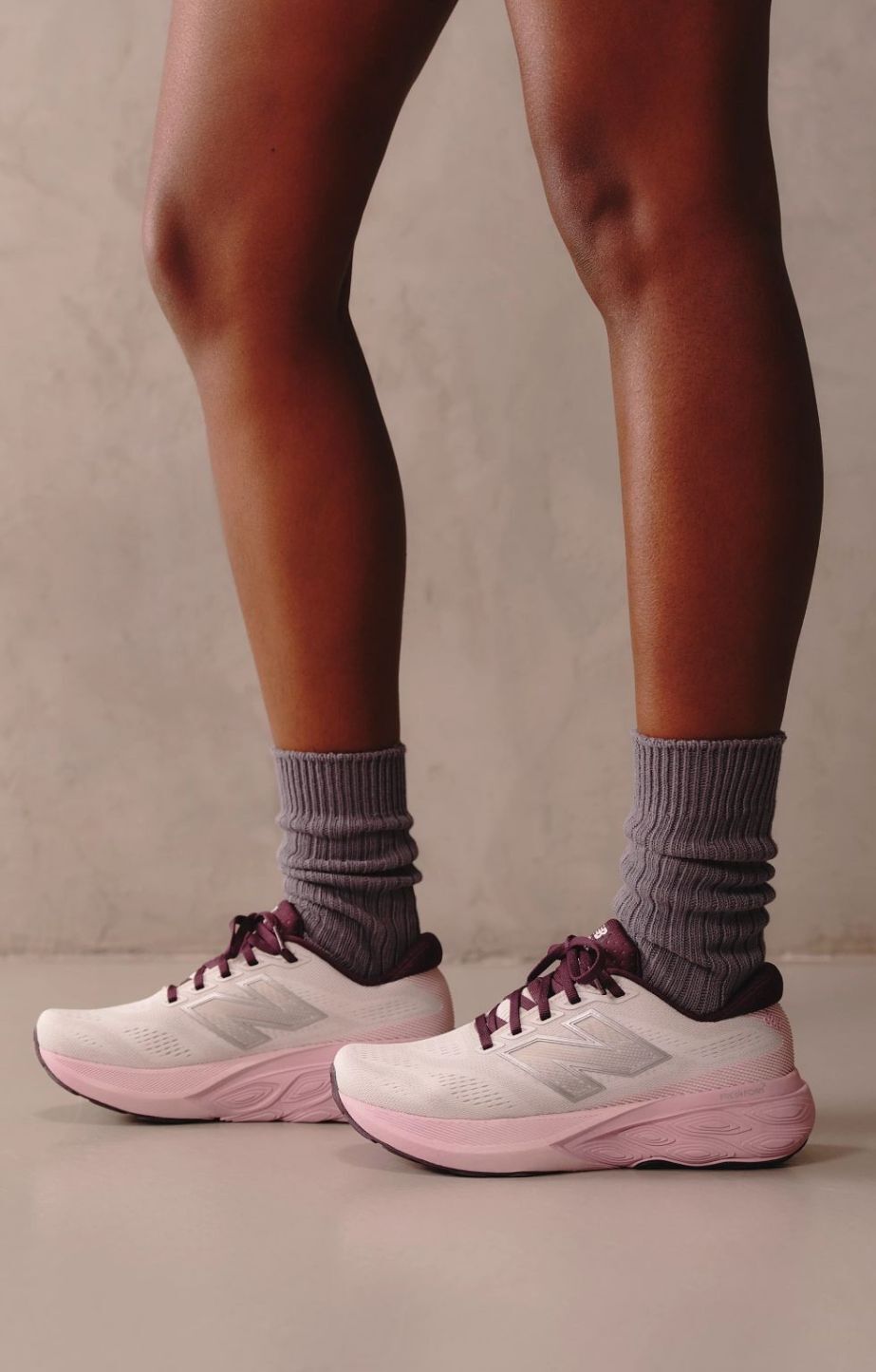 close up of a womans legs wearing new balance fresh foam 1080 running shoes