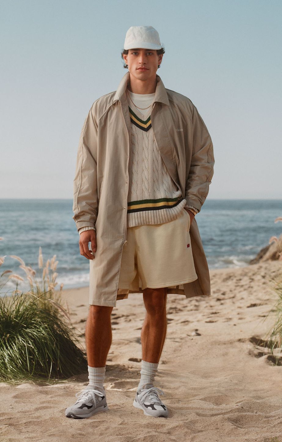 A man standing in the sand in a beach environment wearing New Balance Made in USA apparel and footwear.