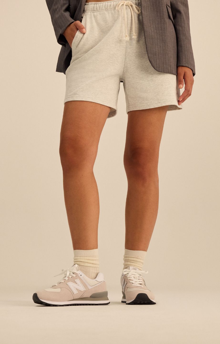 Close up of womans legs wearing new balance 574 sneakers